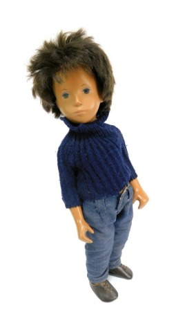 A 1970s full height Sasha doll, Gregor with brown hair and blue eyes, in jumper and jeans on display stand, 42cm high.