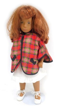 A 1970s Sasha doll, with articulated limb body, with red hair, brown eyes, on stand, 41cm high.