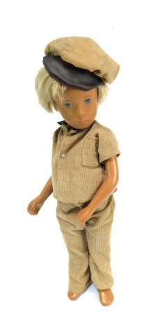 A 1970's Sasha doll, of boy with blonde bob, blue eyes, in cord clothing, 41cm high.