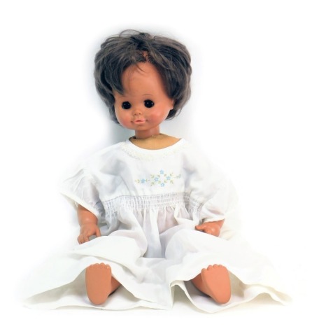 A 1970s cloth doll body, celluloid face, with brown eyes.