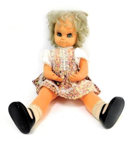 A vintage moving musical doll, with wind up mechanism and roll blue eyes.