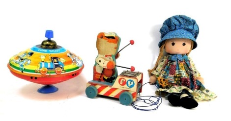 A Fisher Price Teddy pull a long wooden xylophone, a 1970s Holly Hobby doll, and a Chad Valley tin plate toy. (3)