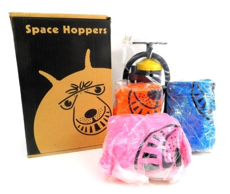 Three space hoppers and pump, in orange, blue and pink.