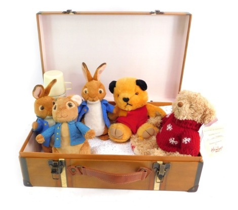 A toy trunk and contents, to include two TY Peter Rabbits, a Rainbow Designs Peter Rabbit, Sooty and a Hamleys Teddy bear.