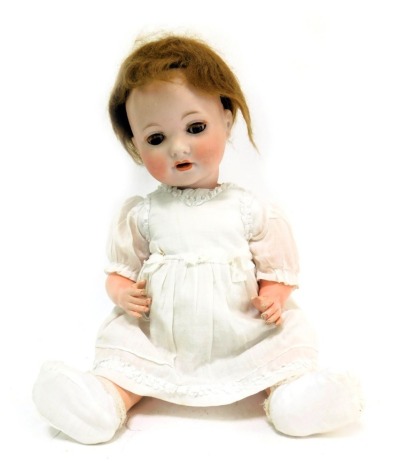 An Armand Marseille German bisque headed doll, No 8, with roll blue eyes and teeth, blond bob, articulated limbs, 44cm high.