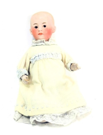 A German bisque headed doll, No 0, stamped Germany 104, with articulated limbs, 24cm high.