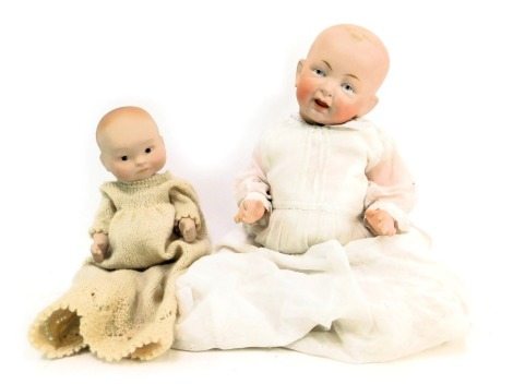 A bisque headed doll, with articulated limbs and body, and a bisque headed doll, stamped DW 79, in knitted gown. (2)