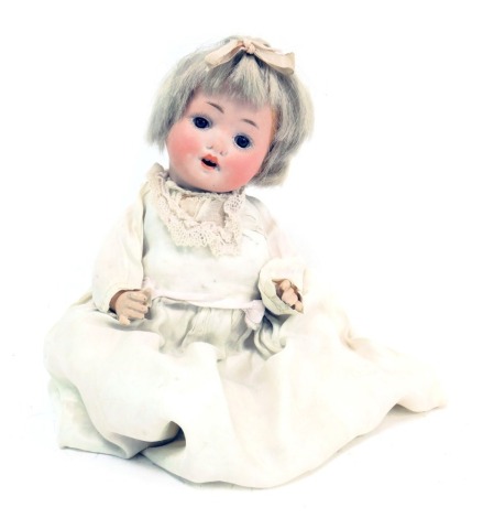 A S & W German bisque headed doll, No 201B - 76, with blue fixed eyes and teeth, blonde bob, with articulated limbs, in metallic evening dress, 22cm high.