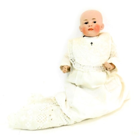 A German bisque headed doll, of child with blonde hair, with fixed eyes and mouth, stamped 2 Germany B, with articulated limbs, in Christening robe, 29cm high.