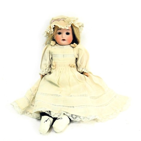 A S & W Germany porcelain bisque headed doll, with roll blue eyes and open mouth, No 24112-0, with material body, 28cm high.