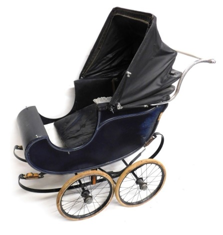 A vintage doll's pram, with chrome frame work, on a blue material carriage.