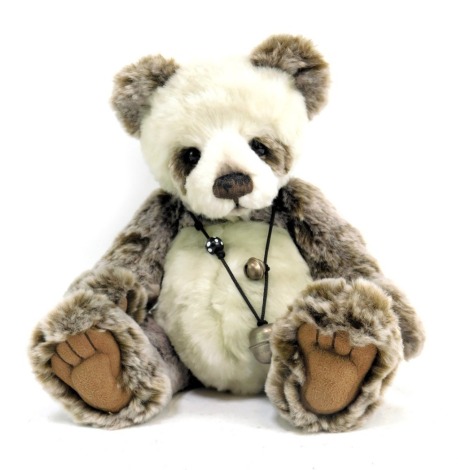 A Charlie Bears Teddy bear, formed as a panda, with carry bag.