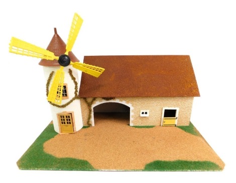 A Starlux thatched cottage model, with windmill.