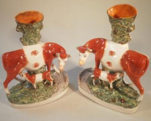 A pair of Staffordshire spill vases