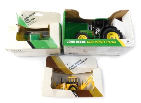 Three Ertl John Deere tractor models, comprising the 4WD tractor, the backhoe/loader, the 6410 MFWD tractor, boxed. (3)