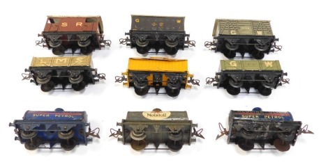 A group of tinplate O gauge rolling stock, including Portland cement wagon, Red wire Gliwo oil tanker, Mobil oil tanker, vented vans, etc.