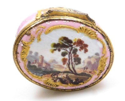 A late 18thC French enamel nutmeg grater, of oval form, decorated with landscape reserves against a pale pink ground, the hinged lid opening to reveal a metal grater, enclosing an interior with "Gage de mon amitie" to the base, 47mm wide. - 2