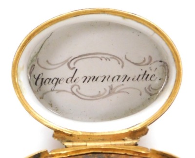 A late 18thC French enamel nutmeg grater, of oval form, decorated with landscape reserves against a pale pink ground, the hinged lid opening to reveal a metal grater, enclosing an interior with "Gage de mon amitie" to the base, 47mm wide. - 4