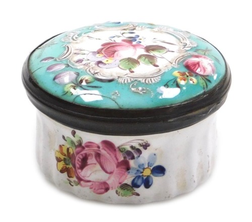 A late 18thC Bilston enamel patch box, of circular form, decorated to the lid in bas-relief with flowers, on a white and turquoise ground, heightened in white with rococo scrolls, the fluted box decorated with floral sprays, 47mm diameter.