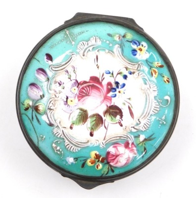 A late 18thC Bilston enamel patch box, of circular form, decorated to the lid in bas-relief with flowers, on a white and turquoise ground, heightened in white with rococo scrolls, the fluted box decorated with floral sprays, 47mm diameter. - 2