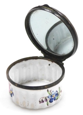 A late 18thC Bilston enamel patch box, of circular form, decorated to the lid in bas-relief with flowers, on a white and turquoise ground, heightened in white with rococo scrolls, the fluted box decorated with floral sprays, 47mm diameter. - 3