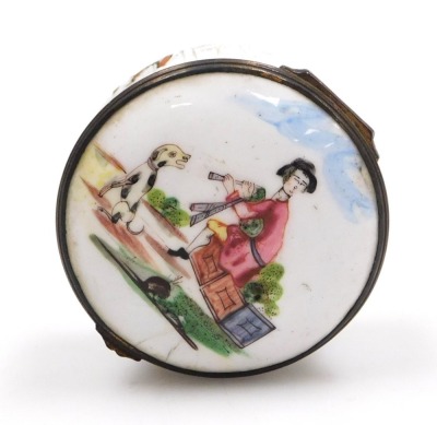 A late 18thC Continental enamel snuff box, possibly French, of cylindrical form, decorated to the lid with a man playing bagpipes, and a seated hound, the box with floral sprays, all on a white ground, 55mm diameter. (AF) - 2