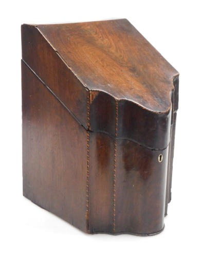 A George III serpentine mahogany knife box, with cross banding, the hinged lid with star burst paterae, opening to reveal a vacant interior, 34.5cm high, 22cm wide.