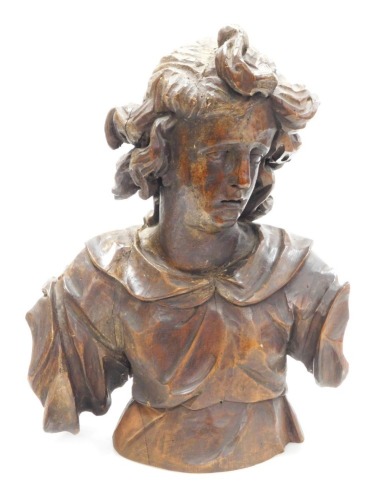 A 17thC European wooden carving, possibly Flemish, half length study of a young man, with flowing hair, 45cm high, together with a red velvet bound stepped base.