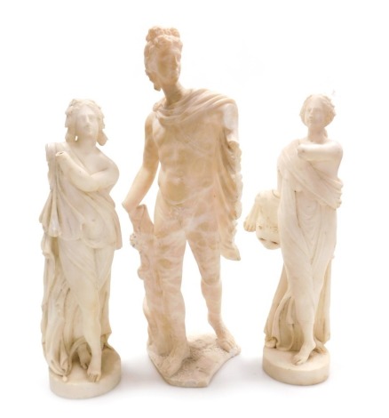 After The Antique. An alabaster sculpture of The Apollo Belvedere, 45cm high, and two further figures after The Antique, of goddesses, raised on circular bases, 37.5cm high. (AF, 3)