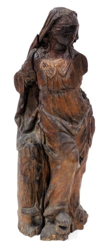 An 18thC Flemish wooden carving, of a lady in Renaissance attire, carved standing against a tree, 64cm high.