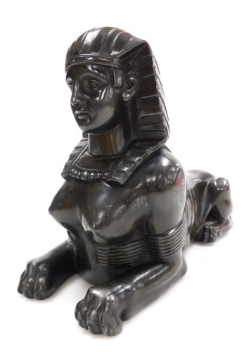 A late 19thC spelter model of a sphinx, in recumbent pose, 28cm wide.