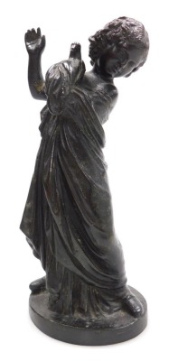 A late 19thC Continental bronze figure of a girl, modelled standing in classical robes with a dove in her left arm, raised on an oval base, 23cm high.