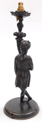 An early 19thC Continental bronze female figure, converted to an electric table lamp, modelled in standing pose, with her legs crossed, holding a cornucopia of fruit, beneath a scrolling stemmed drip tray, raised on a circular wooden base, 38cm high. - 2