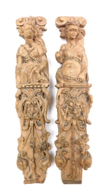 A pair of 17thC carved oak caryatids, each depicting a semi clad half figure of a woman, beneath a doric capital, above carved masks, fruit and flowers, 44cm high.