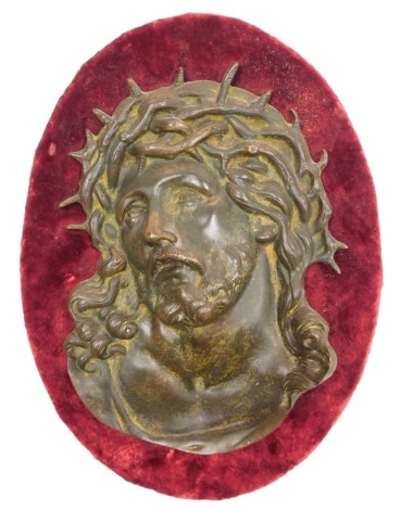 An early 19thC bronze relief plaque of Ecce Homo, after Guido Reni, on a red velvet backing, plaque 28cm x 19cm.