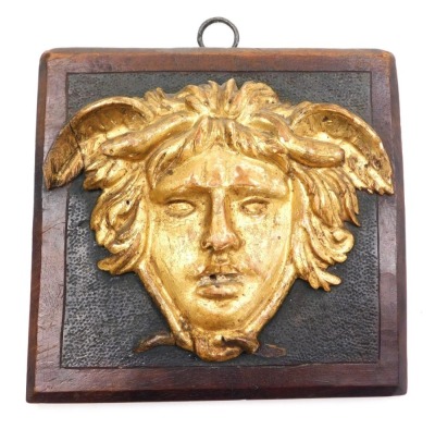 An 18thC French gilt wood mask of Mercury, oak backed, 16cm x 17cm.