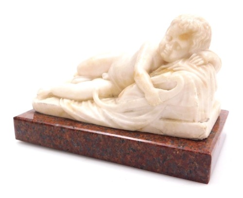 An early 19thC alabaster figure of a sleeping Cupid, after Du Quesnoy, carved recumbent on a draped raised cushion, the bow in his right hand, raised on a red marble base, 18cm wide.