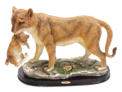 A Juliana Collection resin figure group of a tigress and cub, modelled by C Tosa, on an oval base, 36cm wide.