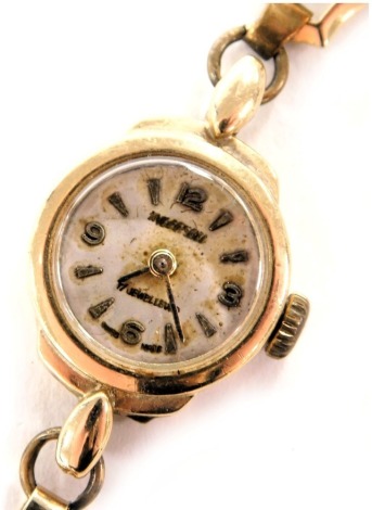 A mid century Ingersoll lady's 9ct gold cased wristwatch, the circular silvered dial with Arabic numerals at quarters, 17 jewel movement, on a 9ct gold bracelet strap, with snap clasp and safety chain as fitted, 13.7g all.