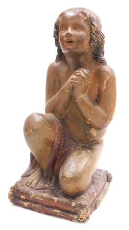 An early 19thC terracotta figure of a kneeling boy, modelled in prayer, raised on rectangular cushion base, 41.5cm high.