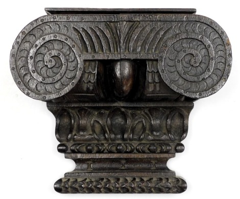 An early 19thC oak wall bracket, carved as a composite capital, 20cm high, 24cm wide.