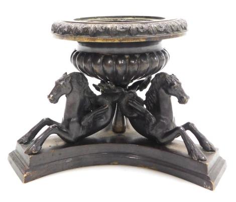 A 19thC bronze vase or encrier, of semi fluted urn form, raised on three hippocampus, raised on a triform base, 10cm high.