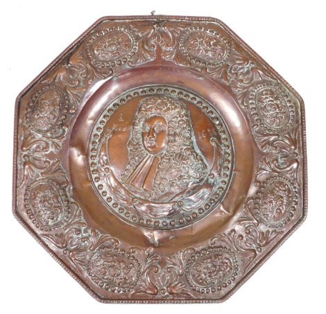 A 19thC copper wall plaque, of octagonal form, embossed centrally with a bust portrait of King Louis XIV 1686, in a border embossed with ovals of pomegranates, flowers, and foliate scrolls, 59cm wide.