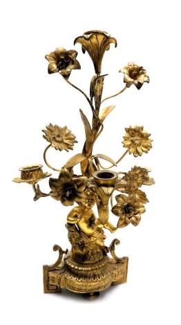 A mid 19thC Continental ormolu four branch candelabrum, cast with flowers and leaves, the base with a putto, raised on scroll turned feet, 39cm high.