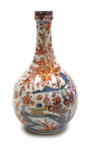 A 19thC Chinese Imari porcelain bottle vase, decorated in blue with a river landscape, over decorated with flowers, 23.5cm high.