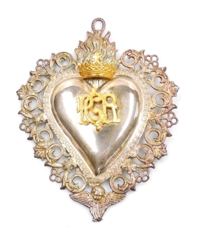 A 19thC Continental Ex Voto sacred silver heart, with crowned flamed finial and bearing the monogram initials RCR, 23cm high.