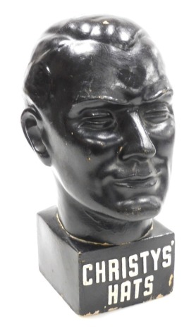 A mid century Christys' Hats black painted advertising bust, 34cm high.