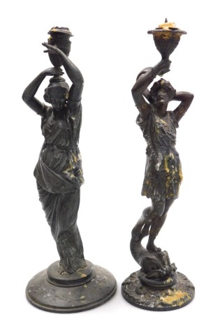 Two 19thC spelter candlesticks, one cast as a classical maiden, with an urn on top of her head, 39.5cm high, the other of a classical figure atop a sea serpent, 37.5cm high. (2)