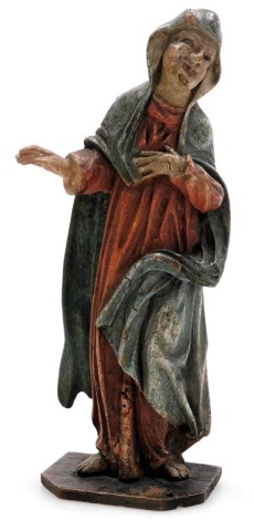 An 18thC religious figure of a female saint, painted in red, blue and flesh colouring, 14cm high.