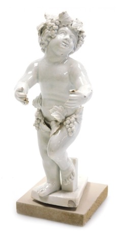 An early 19thC Italian white glazed figure of Bacchus, model standing, 17cm high. (AF)